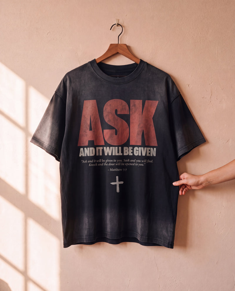 Ask and It Will Be Given faded black tee on a hanger, front print