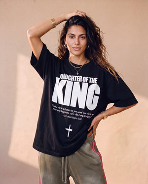 Daughter of the King tee, black, front print, woman, hand in hair thigh up