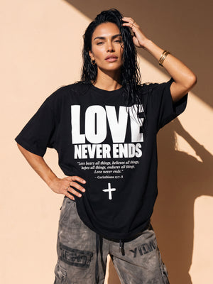 Love Never Ends tee, black, front print, woman, hand in hair thigh up