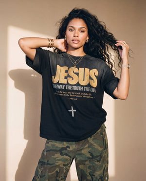 Jesus the Way the Truth the Life faded black tee, front print, woman with curly hair lifting both hands to her hair, worn with camo pants