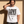 Love Never Ends tee, white, front print, man, hand on neck thigh up