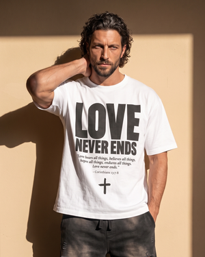 Love Never Ends tee, white, front print, man, hand on neck thigh up