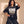 King of Kings faded black tee, front print, woman with a hand in her curly hair and one on her hip, styled with baggy cargo pants