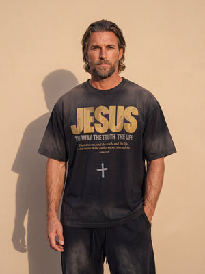 Jesus the Way the Truth the Life faded black tee, front print, man with a beard and hands in his pockets against a sunlit wall