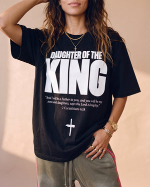 Daughter of the King tee, black, front print, woman, hand in hair waist up