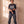In the Beginning God faded black tee, full body view of a man with crossed wrists in ripped baggy jeans and sneakers, Christian streetwear