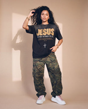 Jesus the Way the Truth the Life faded black tee, full body view of a woman in camo cargo pants and sneakers, one hand on her hip