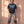 Pray Until Something Happens faded black tee, full body view of a man in ripped camo cargo pants and work boots, hands in his pockets