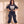 King of Kings faded black tee, full body view of a smiling woman with hands on her hips in cargo pants and work boots