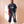 Jesus Is King faded black tee, full body view of a man with braids in sweatpants and high top sneakers, hands in his pockets