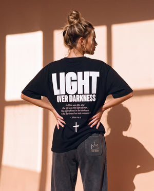 Light Over Darkness tee, black, back print edition, woman, back print hands on hips