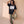 Daughter of the King tee, black, front print, woman, leaning on wall full body