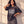 In the Beginning God faded black tee, woman with a hand behind her head and one on her hip, half figure shot of the oversized cut