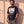 King of Kings faded black tee, three quarter view of a bearded man with one hand in his pocket and the oversized fit hanging loose