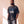 Jesus Is King faded black tee, front print, bearded man with hands in his pockets, John 1:1 verse under JESUS IS KING