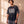 In the Beginning God faded black tee, front print, man standing relaxed with a smartwatch, Christian streetwear with a boxy oversized fit