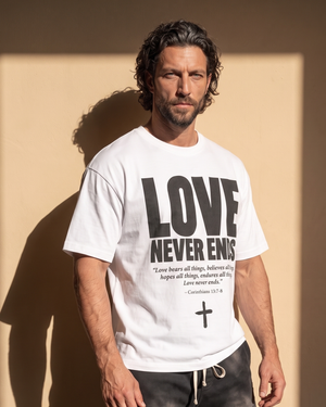 Love Never Ends tee, white, front print, man, three quarter thigh up
