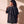 Heart Wide Open faded black tee, back view of a woman with a curly ponytail touching her shoulder, crown logo below the collar