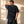 Heart of a Lion faded black tee, back view of a man with a hand behind his head, small crown logo below the collar