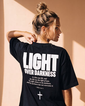 Light Over Darkness tee, black, back print edition, woman, back print over shoulder