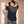Jesus the Way the Truth the Life faded black tee, back view of a woman with both hands in her curly hair, small crown logo below the collar