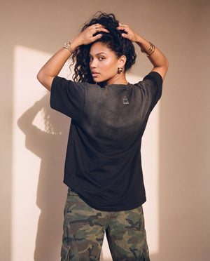 Jesus the Way the Truth the Life faded black tee, back view of a woman with both hands in her curly hair, small crown logo below the collar