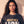Heart of a Lion faded black tee, close up portrait of a woman with curly hair above the HEART OF A LION lettering