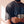 Jesus Is King faded black tee, close up on a man's sleeve and chest, distressed JESUS IS KING lettering and the dropped shoulder seam