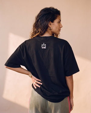 Daughter of the King tee, black, back print, woman, back view crown logo thigh up