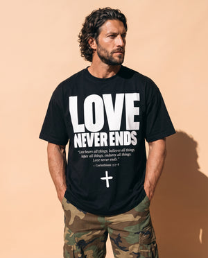 Love Never Ends tee, black, front print, man, three quarter thigh up