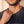 In the Beginning God faded black tee, close up of a man's jaw and hand at the ribbed collar, the top of the print just in frame