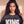 King of Kings faded black tee, close up portrait of a woman with curly hair and a cross necklace above the large KING lettering