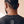 Jesus Is King faded black tee, close up of the back neckline on a man with braids, crown logo and THE WORD printed below the collar