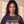 In the Beginning God faded black tee, close up portrait of a woman with curly hair and a cross necklace above the large GOD lettering