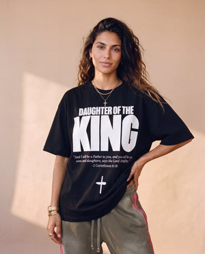 Daughter of the King tee, black, front print, woman, hand on hip thigh up