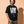 Love Never Ends tee, black, front print, man, hands in pockets thigh up