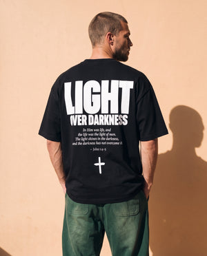Light Over Darkness tee, black, back print edition, man, back print look over thigh up