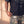 Pray Until Something Happens faded black tee, close up of the hem on a man's hip, the verse and cross just above his hand and camo pants