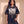 King of Kings faded black tee, front print, woman standing with a hand in her pocket, Revelation 17:14 verse and cross, Christian streetwear