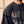Heart Wide Open faded black tee, close up on a man's shoulder and chest, the sunfaded sleeve and the distressed HEART lettering