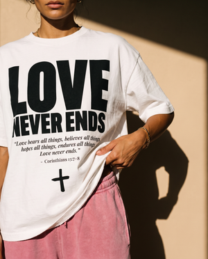 Love Never Ends tee, white, front print, woman, hand on hem close up
