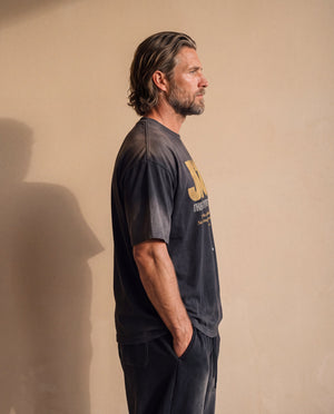 Jesus the Way the Truth the Life faded black tee, side profile of a man with a hand in his pocket, showing the boxy cut and relaxed length