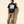The Light of Life tee, black, front print, man, hand in pocket full body