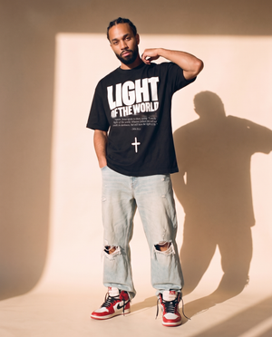 Light of the World tee, black, front print, man, hand on collar full body