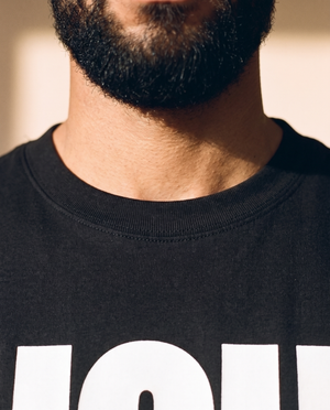 Light of the World tee, black, front print, man, neckline close up