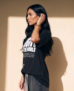 Light of the World tee, black, front print, woman, side profile