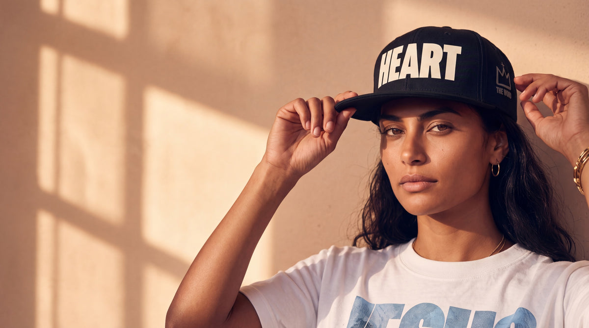 Woman in a HEART snapback, studio portrait