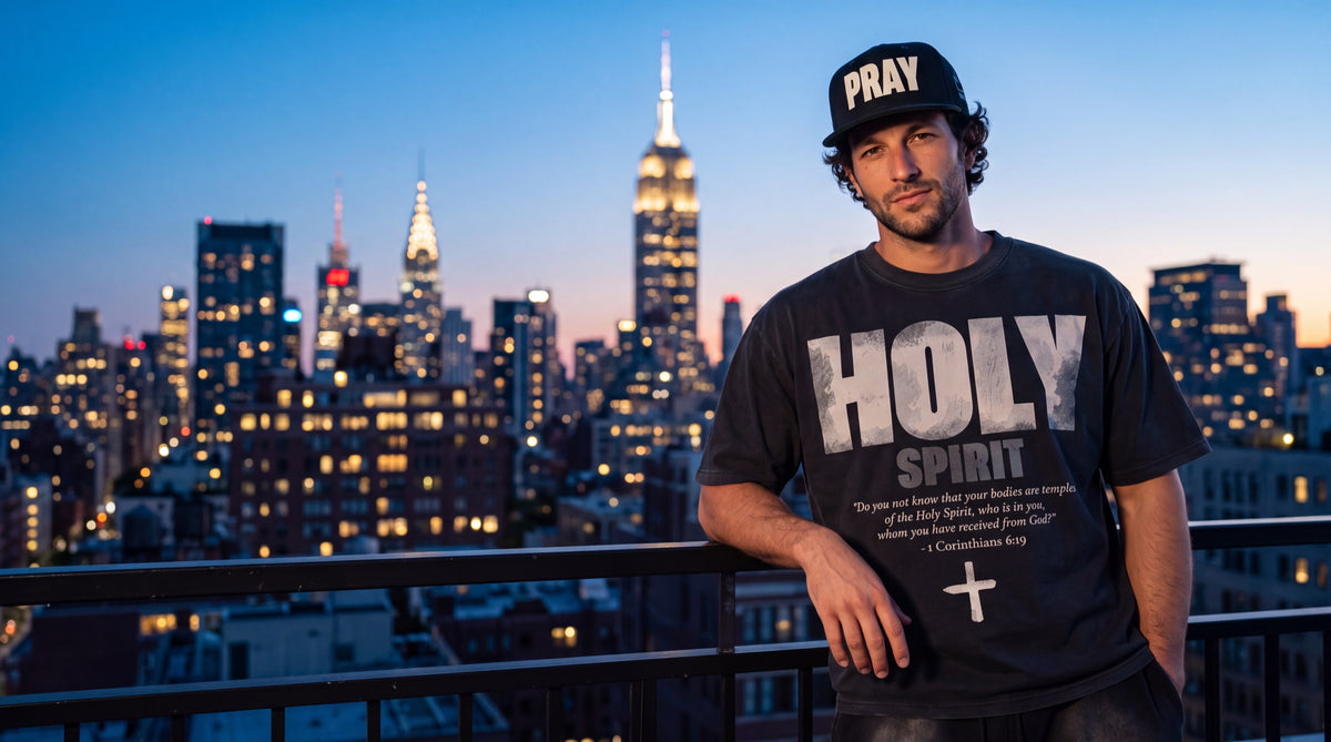 Man in a PRAY snapback on a Manhattan rooftop at blue hour