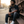 In the Beginning God – Man sitting on Harlem stoop in The Word black T-Shirt