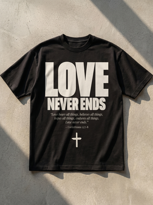 Love Never Ends MONOCHROME tee, black, flat lay, front print with 1 Corinthians 13:7-8 and cross